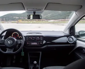 Interieur van Volkswagen Up! te huur in Montenegro. Een geweldige auto met 4 zitplaatsen en een Handmatig transmissie.