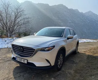 Vooraanzicht van een huurauto Mazda CX-9 in Tbilisi, Georgië ✓ Auto #5564. ✓ Transmissie Automatisch TM ✓ 0 beoordelingen.