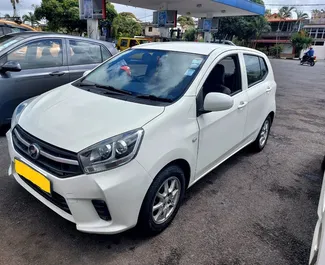 Vooraanzicht van een huurauto Perodua Axia op Mauritius Luchthaven, Mauritius ✓ Auto #7330. ✓ Transmissie Automatisch TM ✓ 0 beoordelingen.