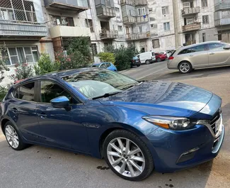 Vooraanzicht van een huurauto Mazda 3 in Tbilisi, Georgië ✓ Auto #9529. ✓ Transmissie Automatisch TM ✓ 0 beoordelingen.