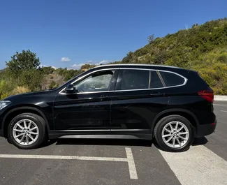 Vooraanzicht van een huurauto BMW X1 in Rafailovici, Montenegro ✓ Auto #7115. ✓ Transmissie Automatisch TM ✓ 1 beoordelingen.