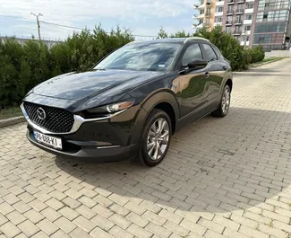 Vooraanzicht van een huurauto Mazda CX-30 in Tbilisi, Georgië ✓ Auto #10904. ✓ Transmissie Automatisch TM ✓ 0 beoordelingen.