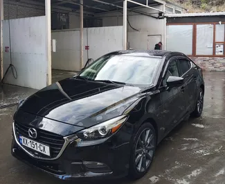 Vooraanzicht van een huurauto Mazda 3 in Tbilisi, Georgië ✓ Auto #11062. ✓ Transmissie Automatisch TM ✓ 0 beoordelingen.