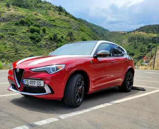 Vooraanzicht van een huurauto Alfa Romeo Stelvio Quadrifoglio in Tbilisi, Georgië ✓ Auto #11484. ✓ Transmissie Automatisch TM ✓ 0 beoordelingen.