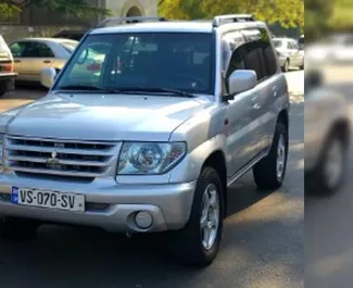 Vooraanzicht van een huurauto Mitsubishi Pajero Io in Tbilisi, Georgië ✓ Auto #11676. ✓ Transmissie Automatisch TM ✓ 0 beoordelingen.