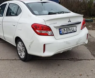 Vooraanzicht van een huurauto Mitsubishi Attrage op de luchthaven van Koetaisi, Georgië ✓ Auto #12030. ✓ Transmissie Automatisch TM ✓ 0 beoordelingen.