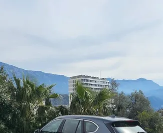 Vooraanzicht van een huurauto BMW X1 in Becici, Montenegro ✓ Auto #11323. ✓ Transmissie Automatisch TM ✓ 0 beoordelingen.