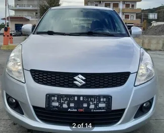 Vooraanzicht van een huurauto Suzuki Swift in Tirana, Albanië ✓ Auto #13087. ✓ Transmissie Automatisch TM ✓ 0 beoordelingen.