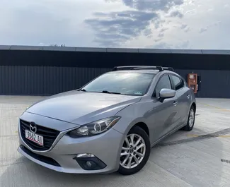 Vooraanzicht van een huurauto Mazda 3 in Tbilisi, Georgië ✓ Auto #13409. ✓ Transmissie Automatisch TM ✓ 0 beoordelingen.