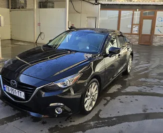Vooraanzicht van een huurauto Mazda 3 in Tbilisi, Georgië ✓ Auto #14066. ✓ Transmissie Automatisch TM ✓ 0 beoordelingen.
