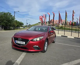 Vooraanzicht van een huurauto Mazda 3 in Tbilisi, Georgië ✓ Auto #14067. ✓ Transmissie Automatisch TM ✓ 0 beoordelingen.