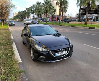 Vooraanzicht van een huurauto Mazda 3 in Tbilisi, Georgië ✓ Auto #14602. ✓ Transmissie Automatisch TM ✓ 0 beoordelingen.
