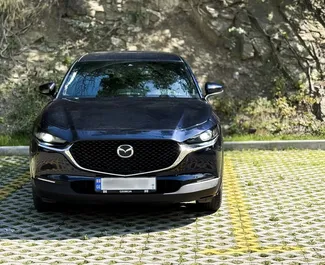 Vooraanzicht van een huurauto Mazda CX-30 in Tbilisi, Georgië ✓ Auto #14631. ✓ Transmissie Automatisch TM ✓ 0 beoordelingen.