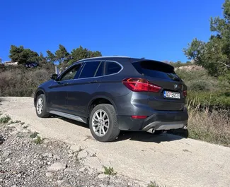 Vooraanzicht van een huurauto BMW X1 op Podgorica Luchthaven, Montenegro ✓ Auto #15686. ✓ Transmissie Automatisch TM ✓ 0 beoordelingen.