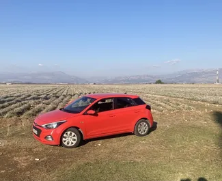 Vooraanzicht van een huurauto Hyundai i20 op Podgorica Luchthaven, Montenegro ✓ Auto #15721. ✓ Transmissie Automatisch TM ✓ 0 beoordelingen.