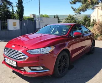 Vooraanzicht van een huurauto Ford Fusion Sedan in Tbilisi, Georgië ✓ Auto #16508. ✓ Transmissie Automatisch TM ✓ 0 beoordelingen.
